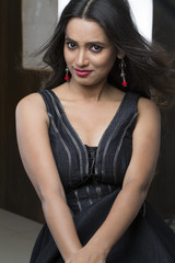 Portrait of young Indian woman wearing black with smile on her face