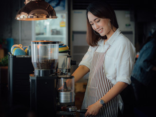 Asian woman drinking coffee in cafe