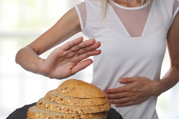 Gluten intolerance and diet concept. Womanl refuses to eat white bread.