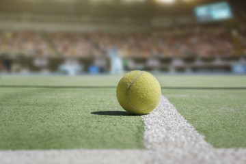 Tennis court background with audience and close up from a tennis ball