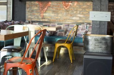 Interior of a modern urban cafe in the morning sunlight. Beautiful interior of a modern industrial style bar.