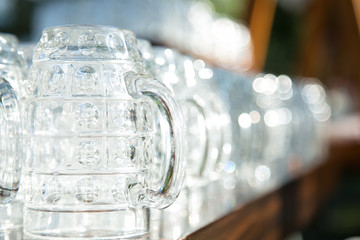 Close up of rows of empty beer glasses .