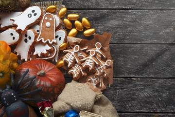 Happy Halloween card. Funny delicious ginger cookie shape ghost and skeleton , bag of sweets and candies with pumpkins and sweets. 