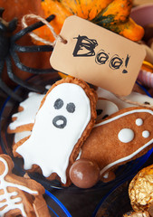 Happy Halloween card. Funny delicious ginger cookie shape ghost and skeleton , bag of sweets and candies with pumpkins and sweets. 