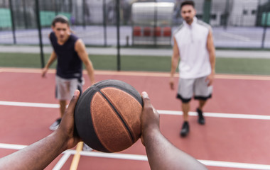 Guys playing basketball