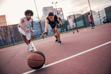 Guys playing basketball
