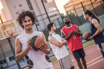 Guys playing basketball