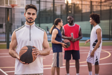 Guys playing basketball