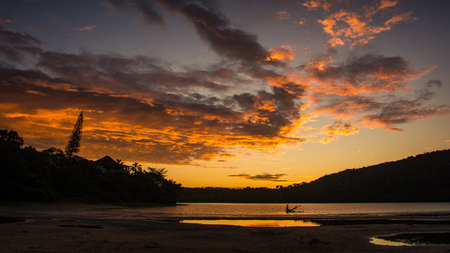 Red and gold sky of sunset reflected in the Gonubie river near East London, South Africa