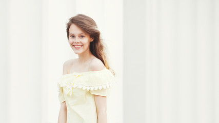 Smiling young pretty girl on sunny city street