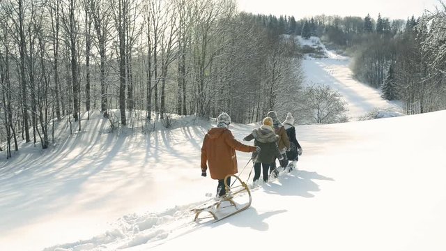 Teenagers on a walk in winter nature.