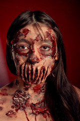 Zombie girl portrait on a red background, halloween