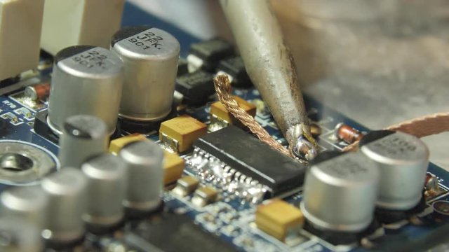 Removing solder from a printed circuit board.