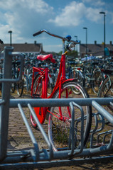 red bike in a bicycle parking rack
