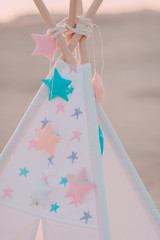 pink vintage wigwam with colorful stars © alekuwka83