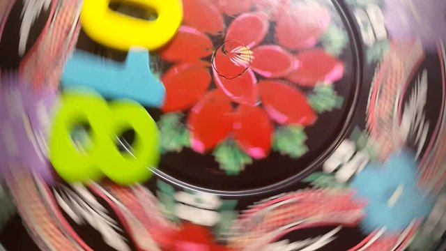 the colorful number 2018 revolves on a round wooden disk with painted flowers ornament