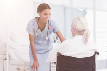 Composite image of smiling nurse assisting female patient in