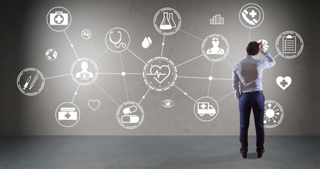Businessman watching medical interface on a wall 3D rendering