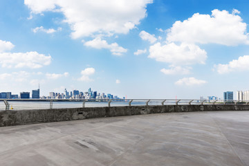 empty concrete floor with cityscape of modern city