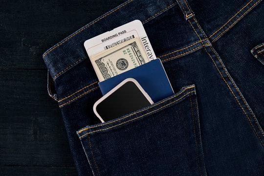 Dollars, smart, passport and plane ticket in your pocket jeans.