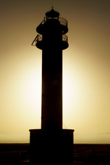 backlit Silhouette of lighthouse during sunset