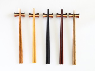 Beautiful collection of wooden chopsticks isolated on white background