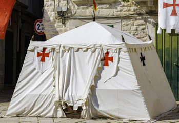 Medieval tent with template cross mounted during a historical reenactment