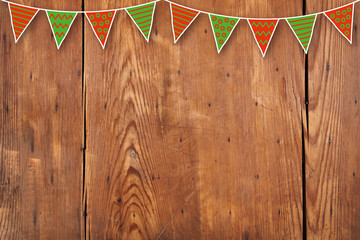 red and green hand drawn garland on wooden background
