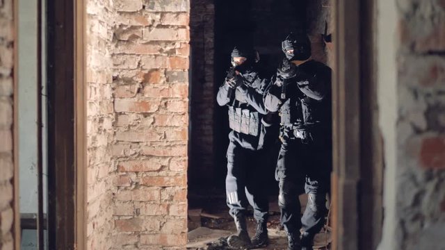 Two swat soldiers explore an abandoned building.