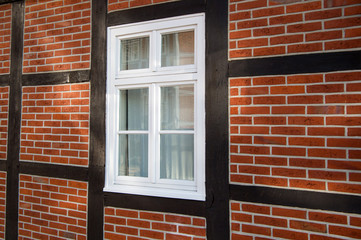 Fototapeta premium Window on red brick house wall