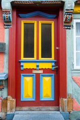 Fototapeta premium Front door with glass windows and painted wooden board