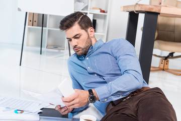 businessman with smartphone and documents