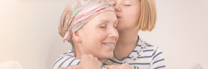 Girl hugging ill mother
