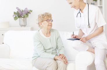 Fototapeta premium Doctor smiling to elderly patient