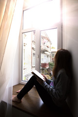 Fototapeta na wymiar girl on a windowsill