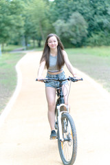 Girl teenager on a bicycle