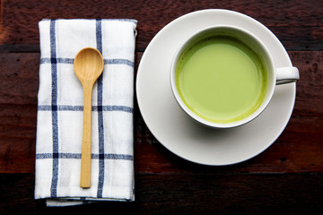 Green tea latte with wooden teaspoon