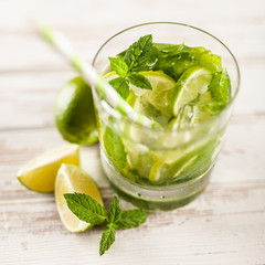 Mojito cocktail on white wood background