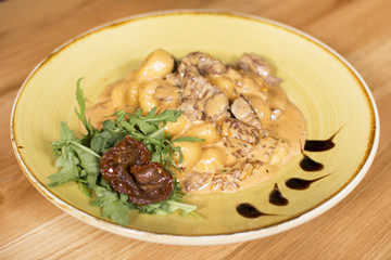 Barbecued beef with roasted potatoes and vegetables. Delicious meat covered with gravy.