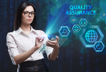 The concept of business, technology, the Internet and the network. A young entrepreneur working on a virtual screen of the future and sees the inscription: Quality assurance