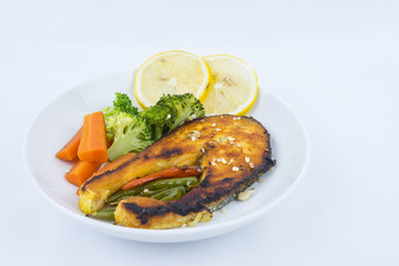 Grilled Salmon with fresh salad and lemon. Selective focus