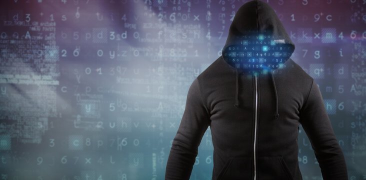 Composite image of male hacker wearing black hoodie while