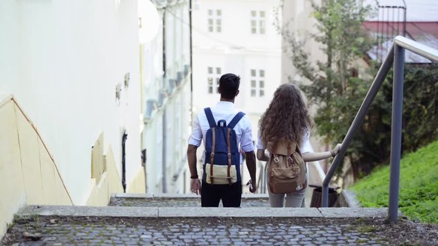Two young tourists with backpacks in the old town.