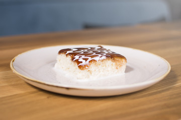 Coconut cake on ceramic plate. Wooden background. Delicious cake dessert served at the restaurant.