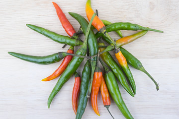 Hot Chilli Peppers isolated on wood board background, close up. Selective focus