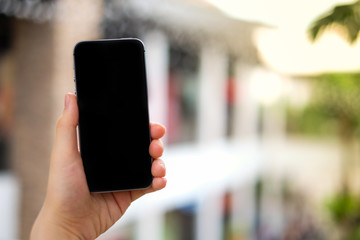 Women's hand using mobile phone (black screen) for search data, space for your content - contact business concept.