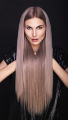 Beautiful woman with long straight trendy blonde hairs. Fashion shot.