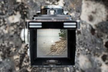 Viewfinder of Vintage Twin Lens Reflex Camera of Rugged Northern Beach Lakeshore