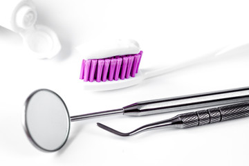 dental care toothbrush with dentist tools on white background