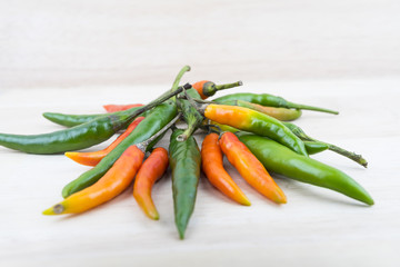 Hot Chilli Peppers isolated on wood board background, close up. Selective focus